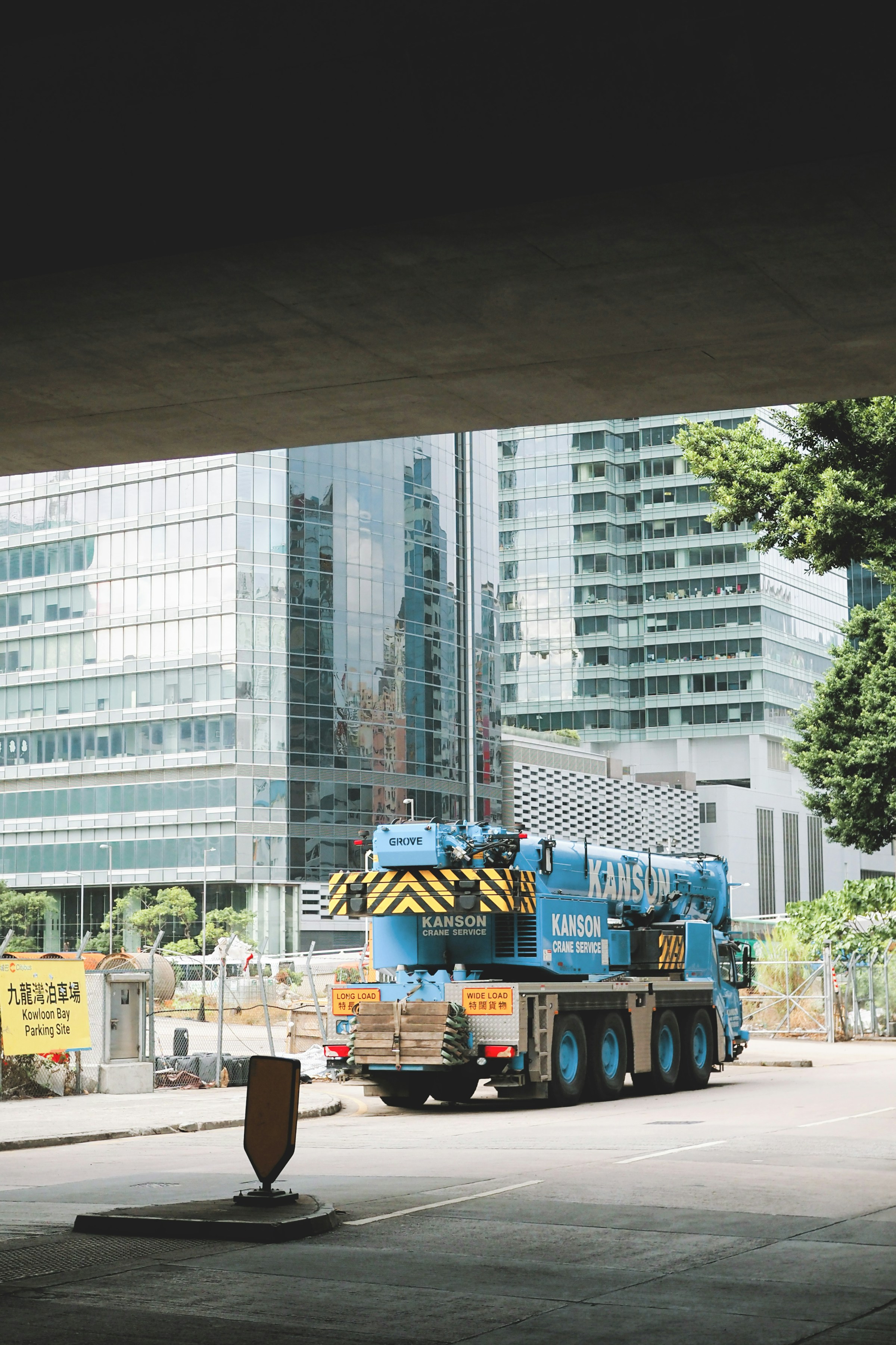 Mobile crane set up beside high-rise towers on a city site